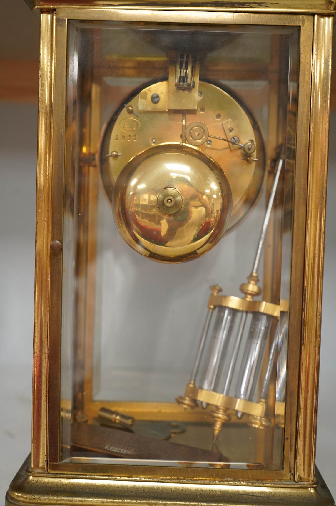 An early 20th century French brass and four glass mantel clock, striking on bell, with pendulum and key, 29cm high